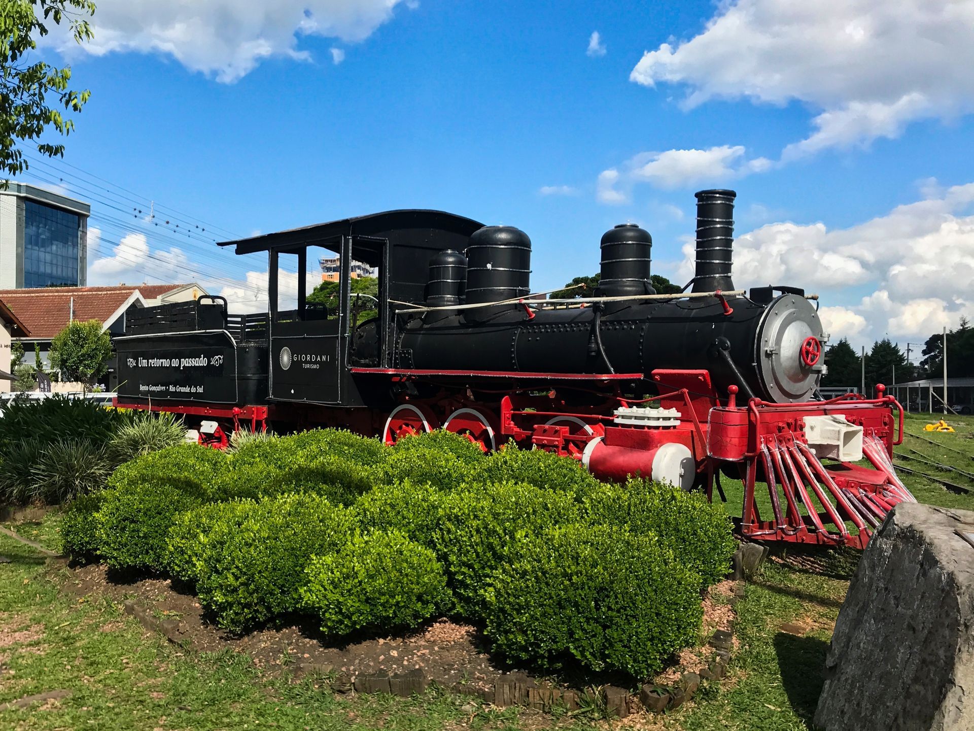 Brown sign above red doors reads 