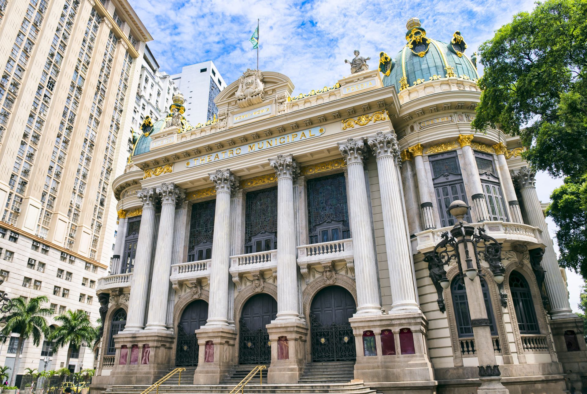 Ornate Beaux-Arts style theater in Rio de Janeiro, Brazil. Features white columns, domes, and elaborate detailing.