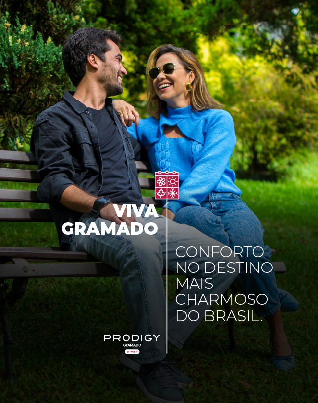 Um anúncio da prodigy mostra uma cidade com muitos prédios e carros.