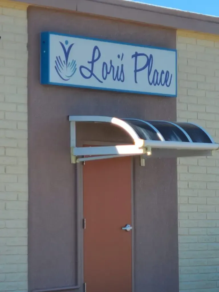 A brick building with a sign that says loris place