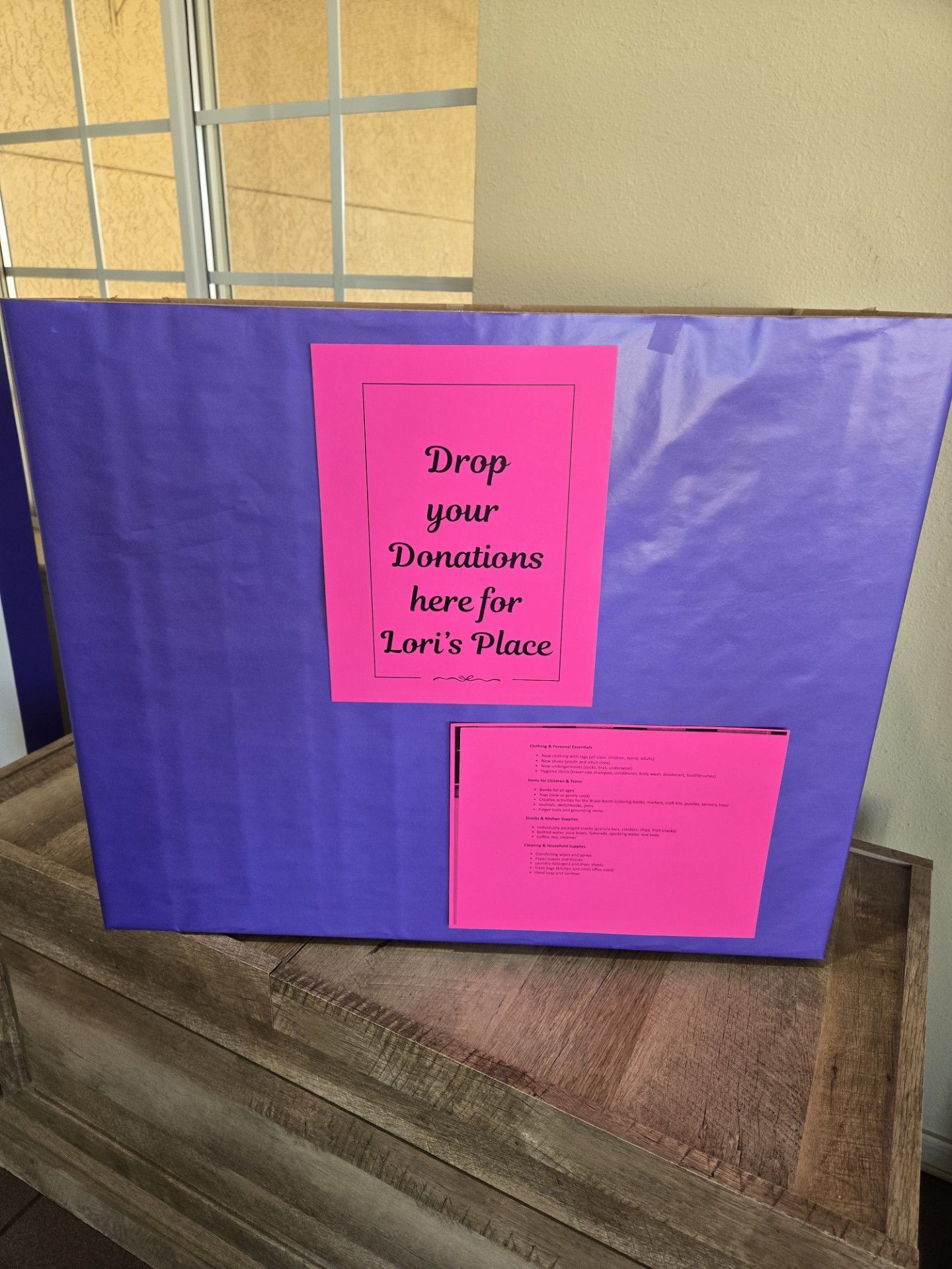 Purple donation box with pink signs: