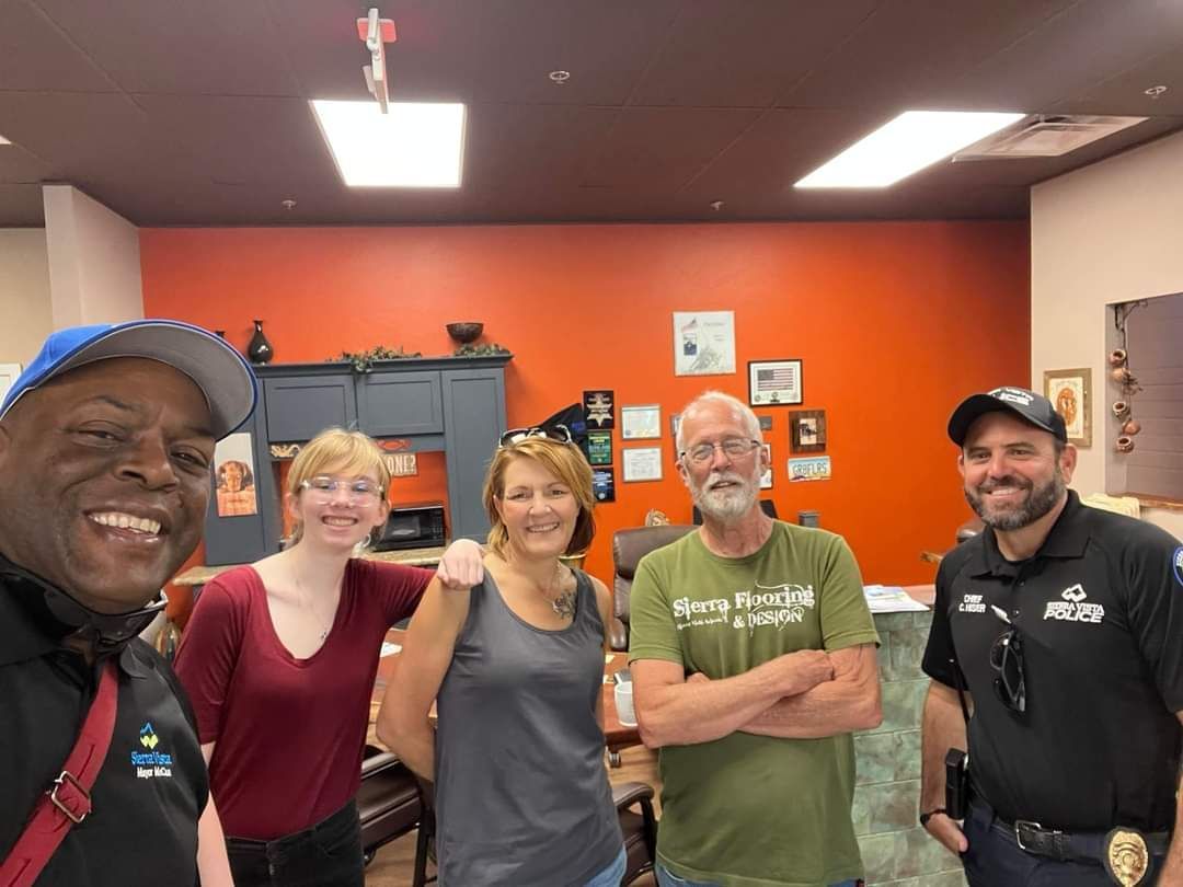 A group of people are posing for a picture in a room.