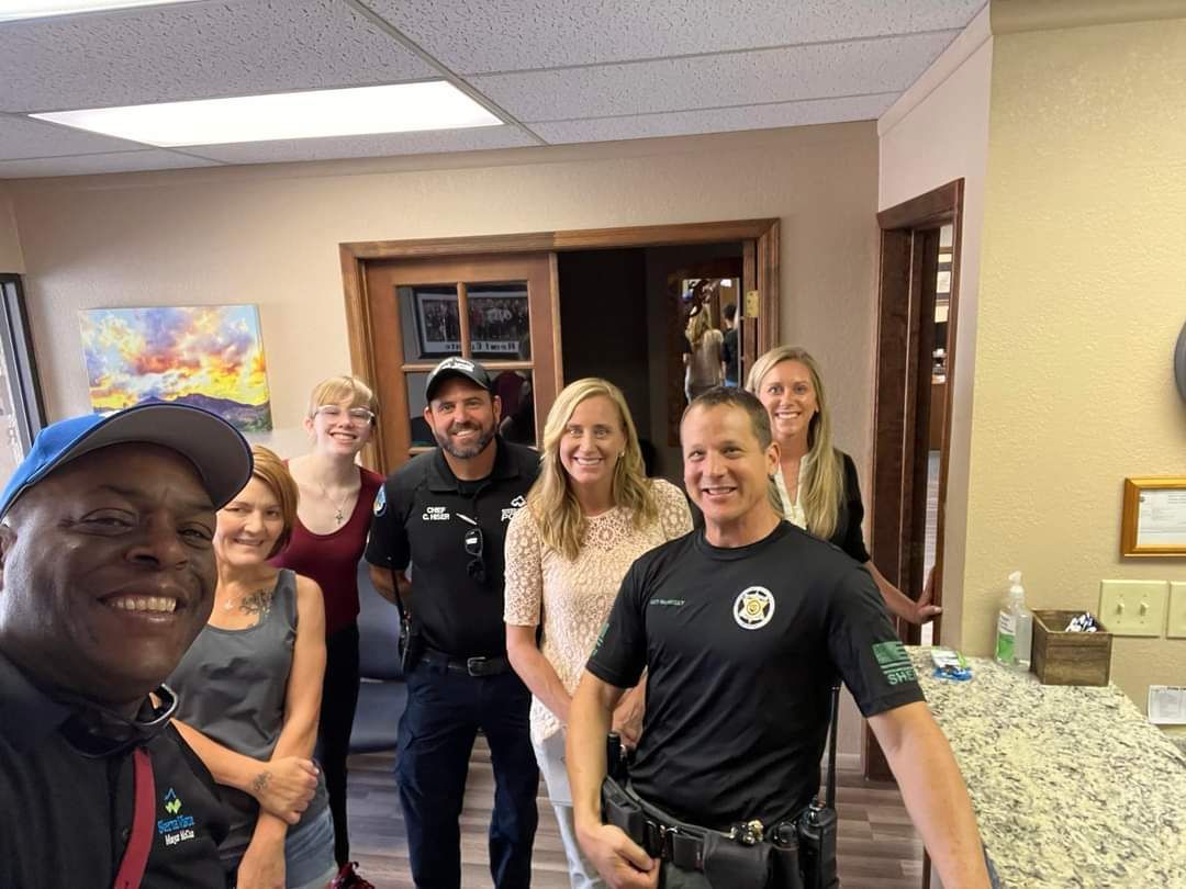 A group of people are posing for a picture in a room.