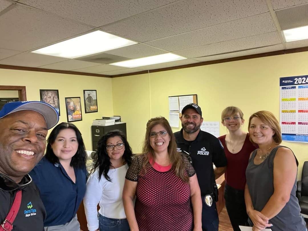 A group of people are posing for a picture in a room.