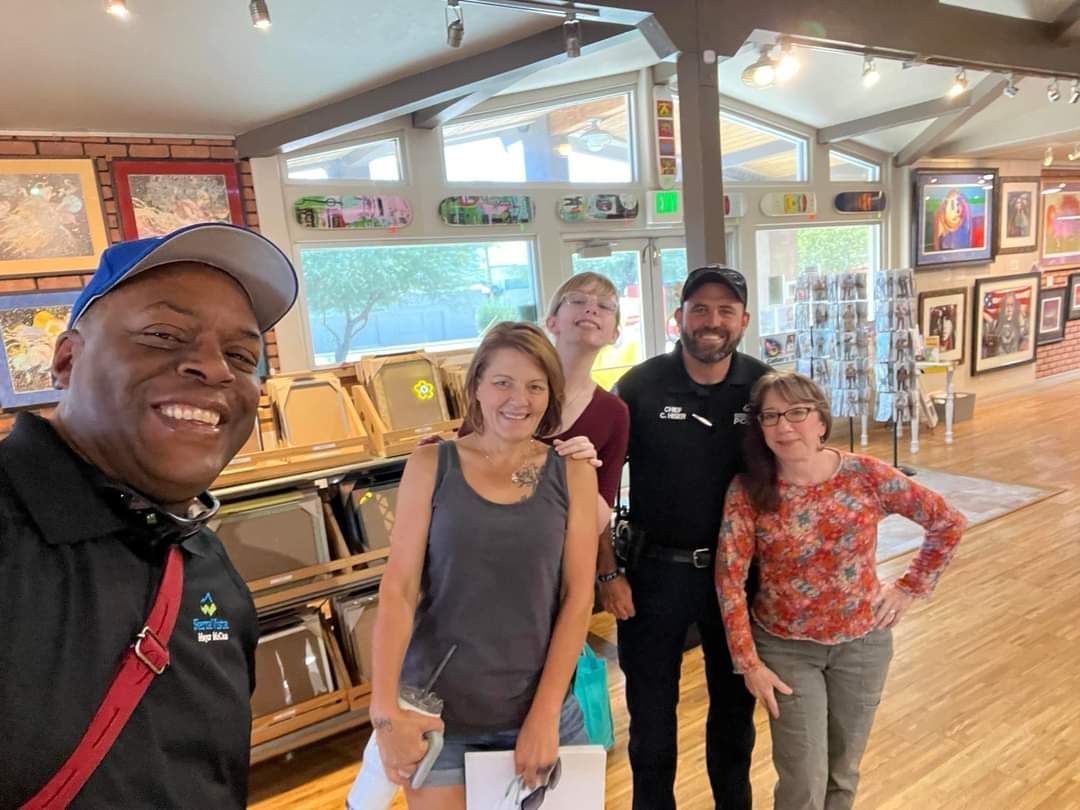 A group of people are posing for a picture in a museum.