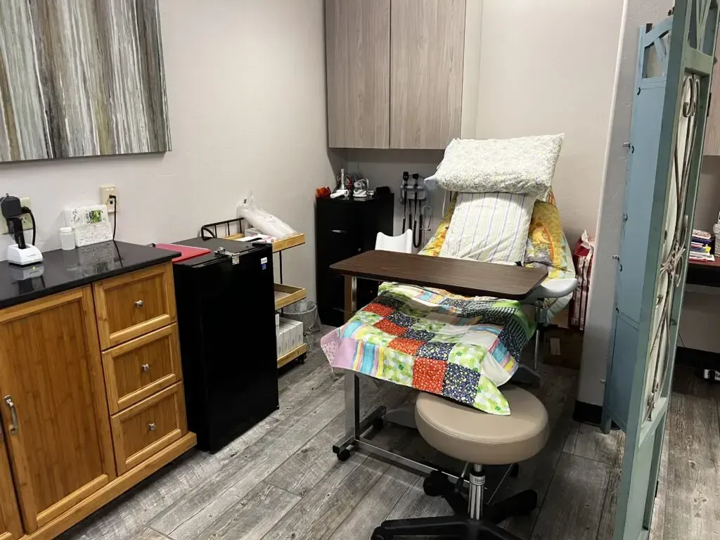 A room with a bed and a table in it.