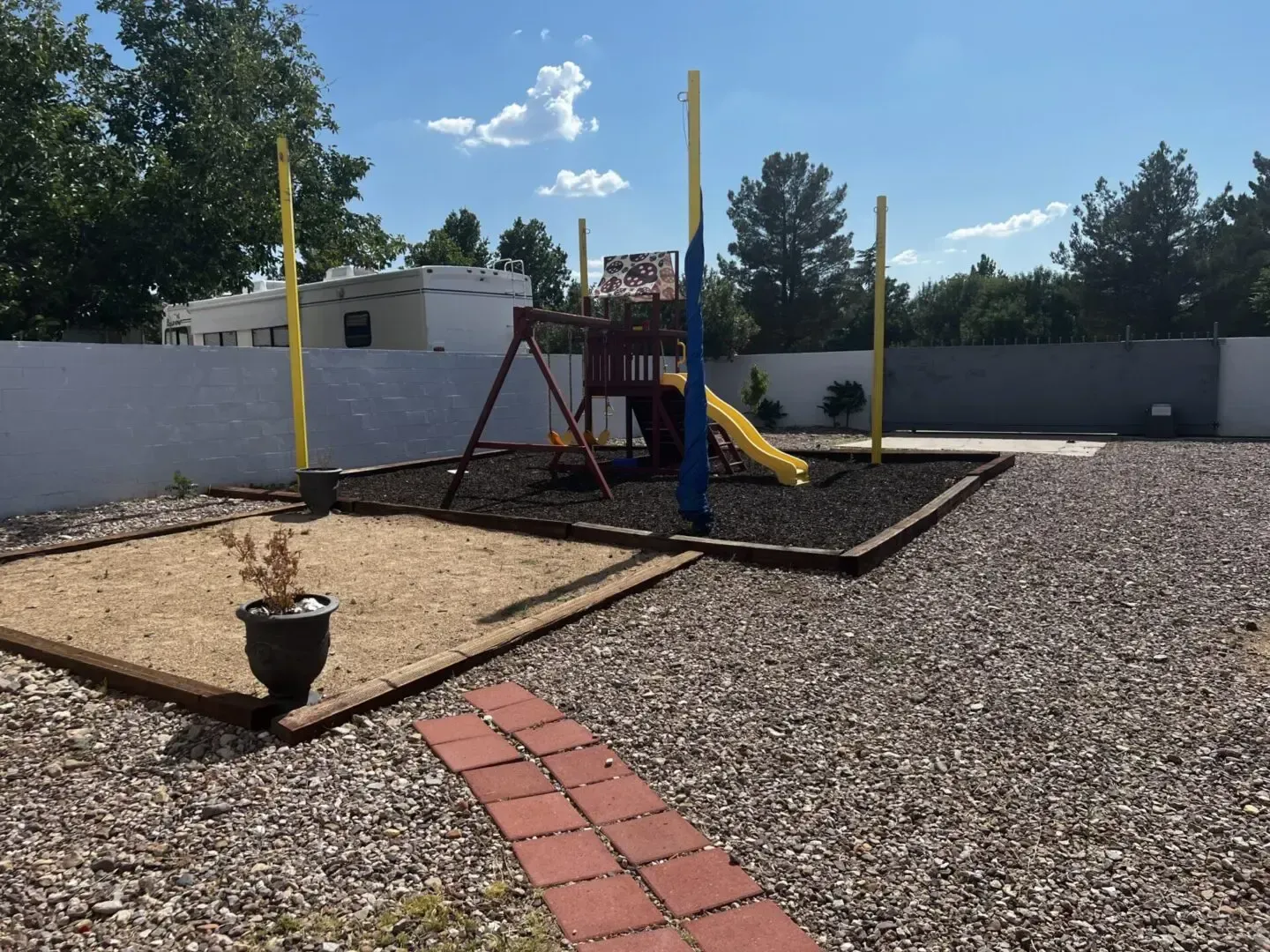 A playground with a swing set and a slide