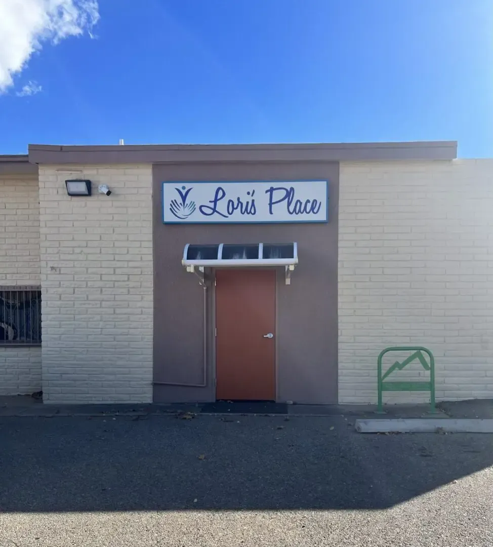 Lori place is a brick building with a brown door
