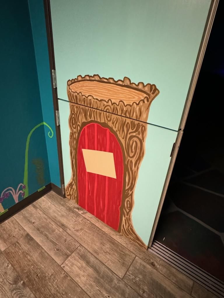 A door with a painting of a fairy door on it.