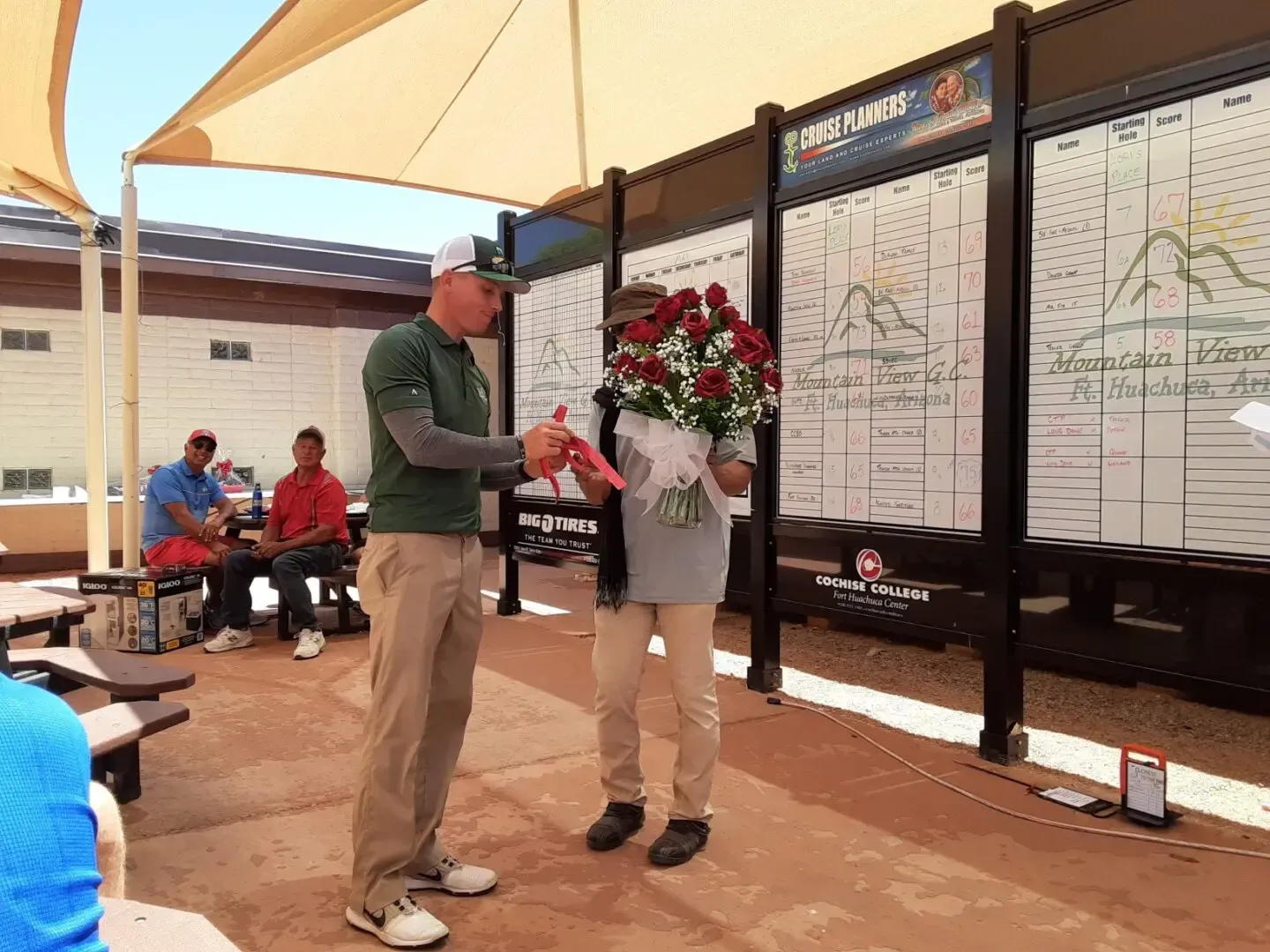A man is giving a woman a bouquet of flowers.