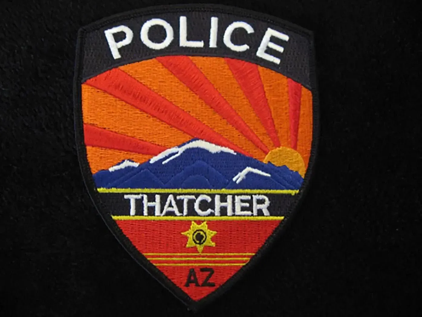 A patch that says police thatcher az on it