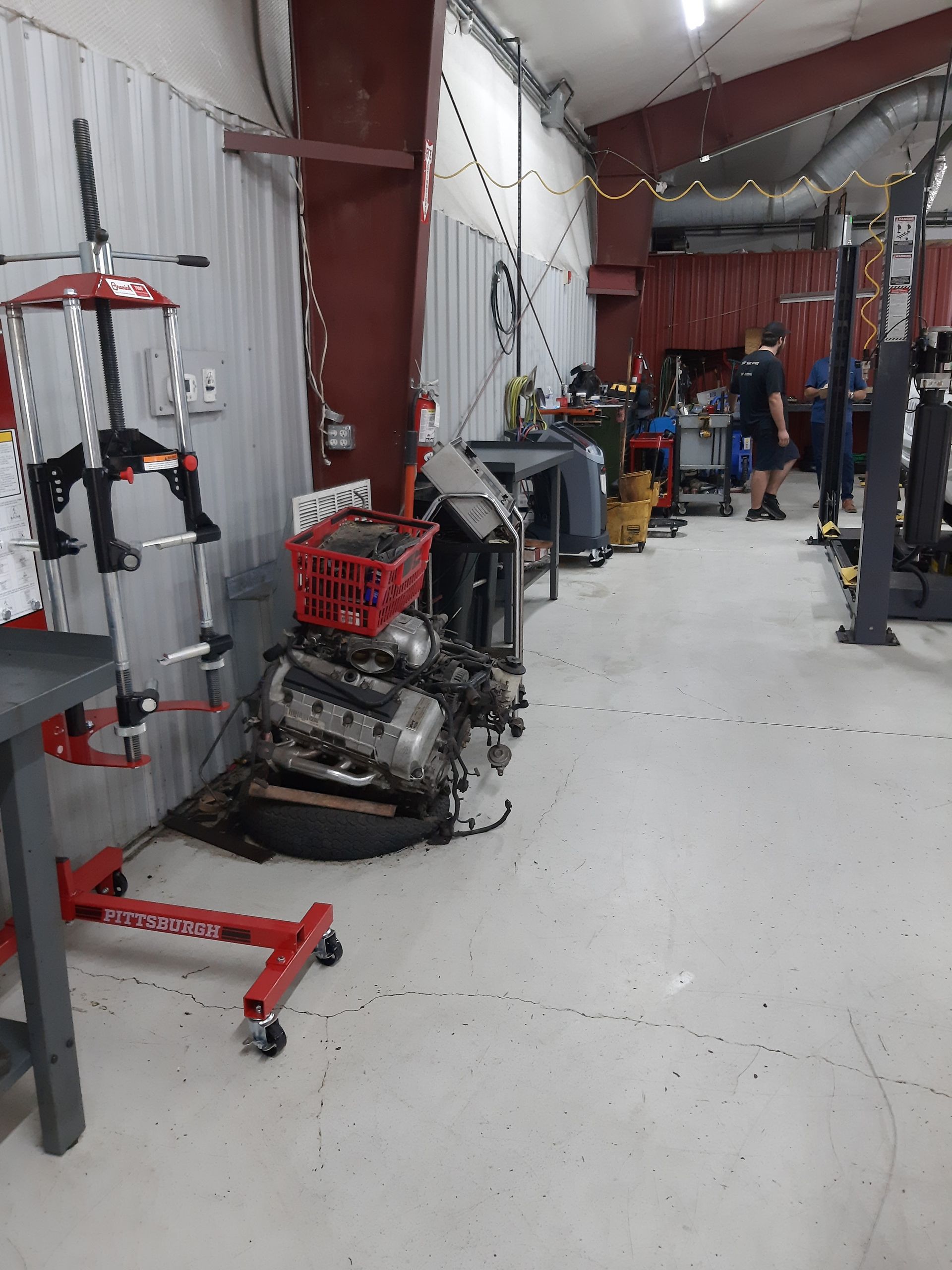 Auto Shop Floor with Disassembled Engine and Alignment Equipment | Tex's Transmissions Complete Auto & Truck Care