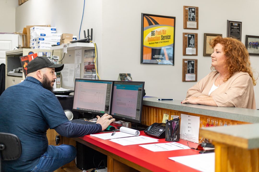 Front Desk Staff Assisting Customer at Reception Area | Tex's Transmissions Complete Auto & Truck Care