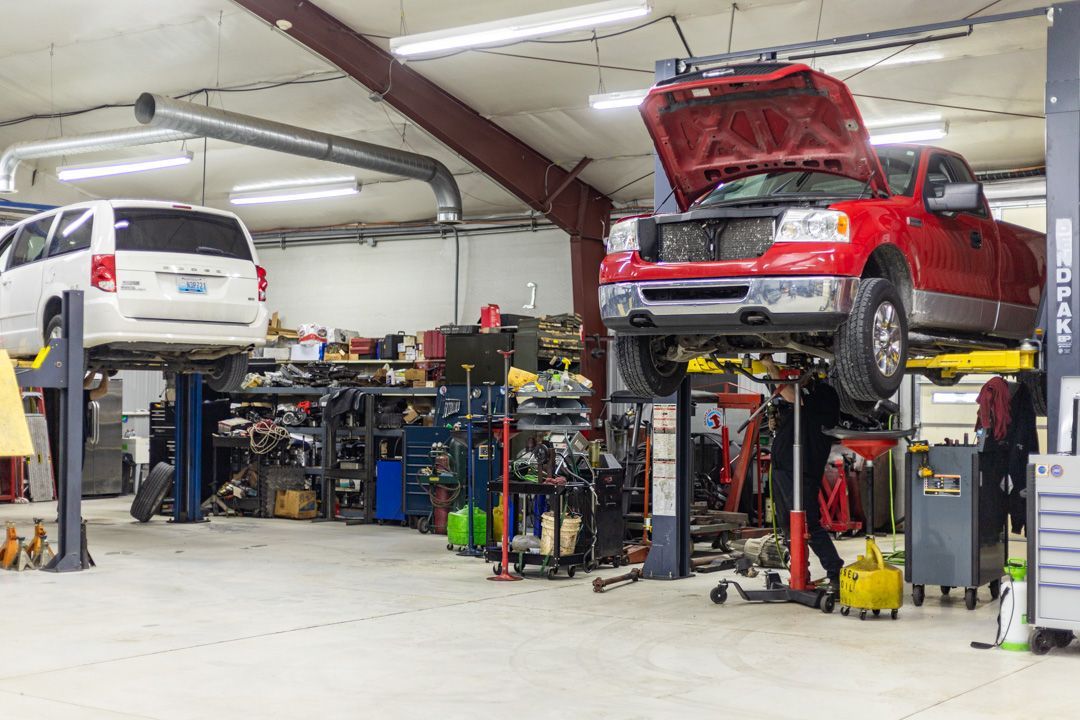 Red SUV with Open Hood on Lift in Auto Repair Facility | Tex's Transmissions Complete Auto & Truck Care