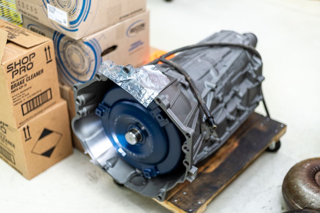 New or Rebuilt Transmission Unit on Dolly with Boxes in Background | Tex's Transmissions Complete Auto & Truck Care