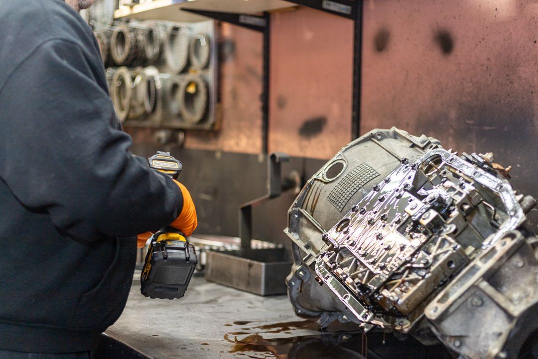 Technician Working on Transmission Assembly with Power Tool | Tex's Transmissions Complete Auto & Truck Care