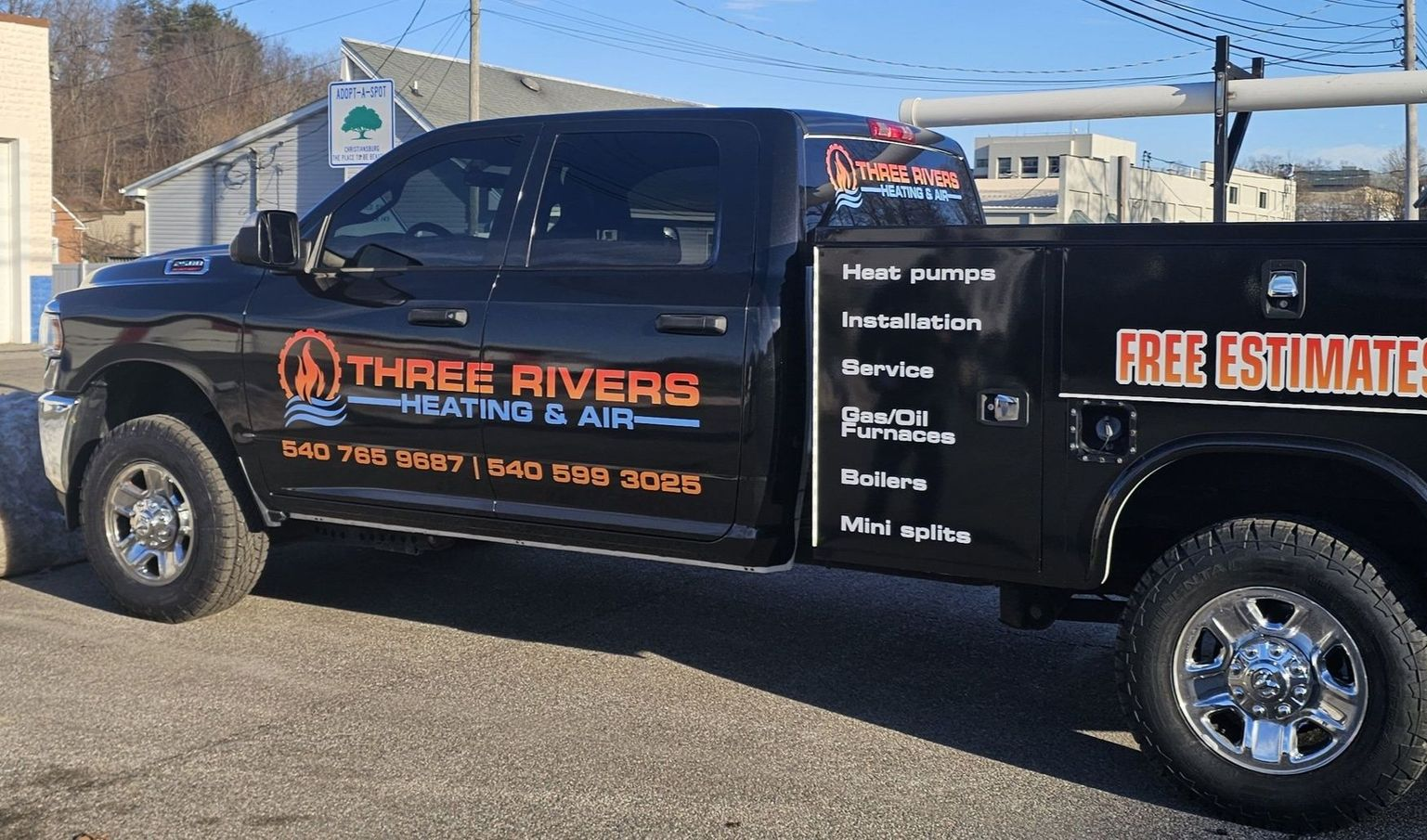 Black Three Rivers Plumbing service truck parked outdoors with free estimates signage