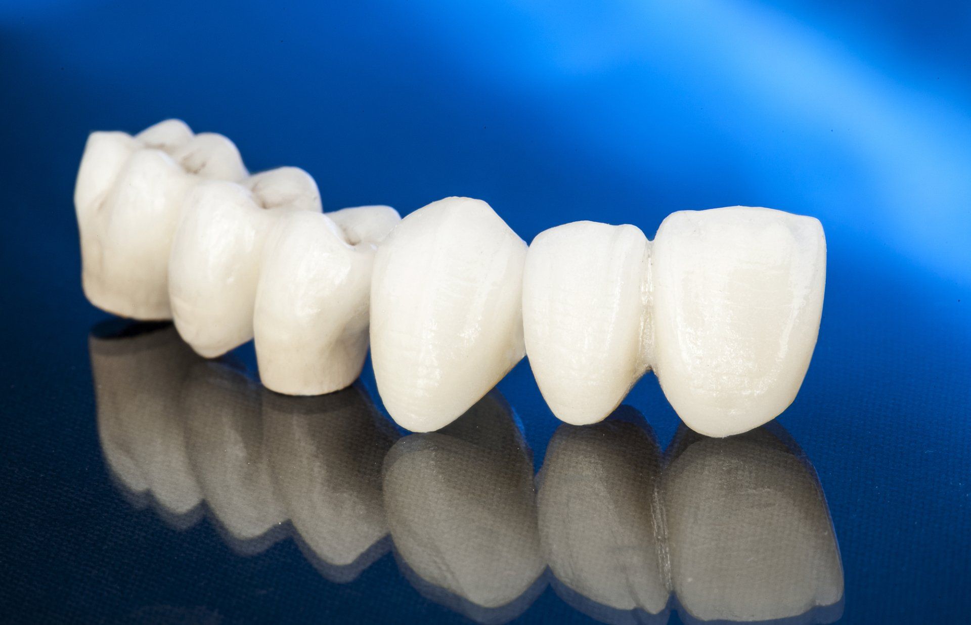 A row of white teeth on a blue surface