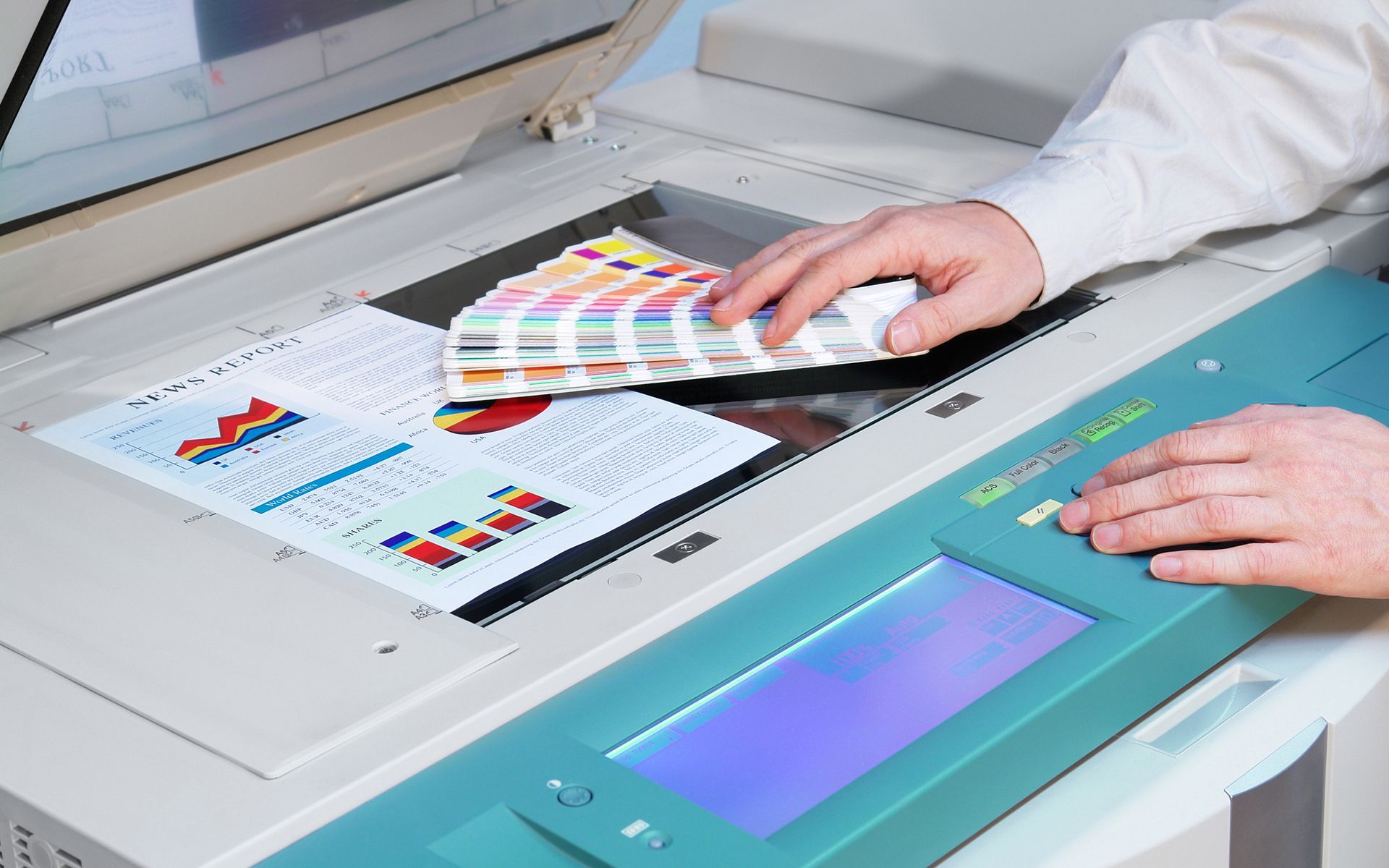 A person is using a copier to scan a book