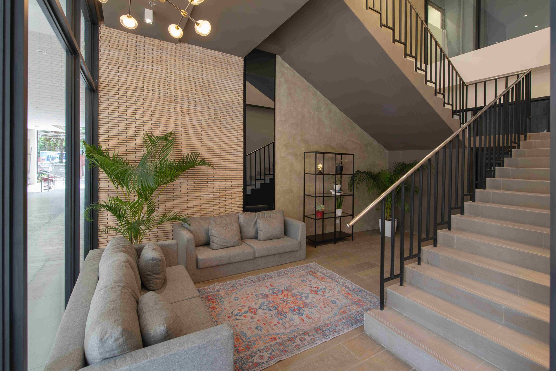 The Grid Lobby with a couch and stairs in coliving Makati.