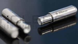 Two silver metal precision measuring tools on a dark reflective surface, one labeled 0.25mm