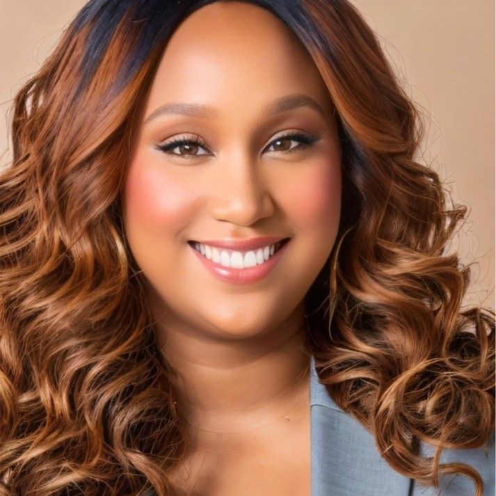 A man with a beard and glasses is wearing a suit and vest.