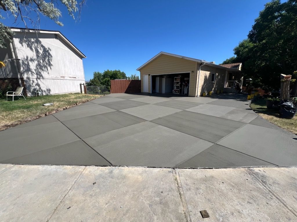 A concrete driveway is being built in front of a house.