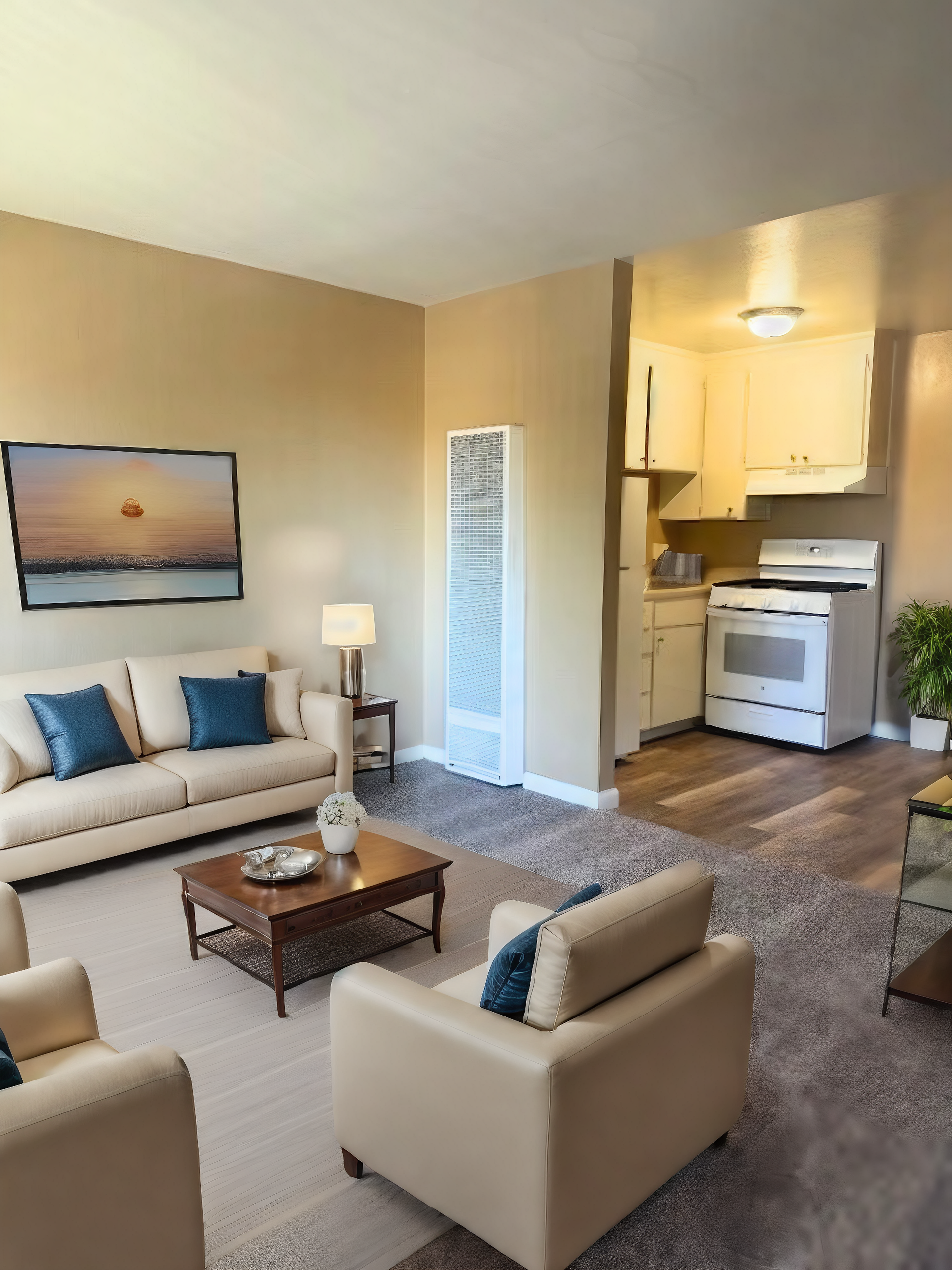 Cozy beige living room with white chairs, sofa, coffee table, lamp, and kitchen nook in background