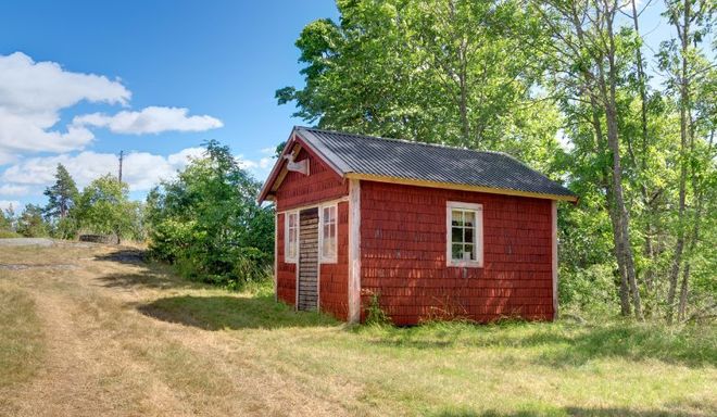 small red shed on side of country road