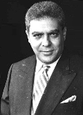 A black and white photo of a man in a suit and tie.