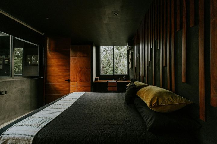 A bedroom with a large bed and a large window.