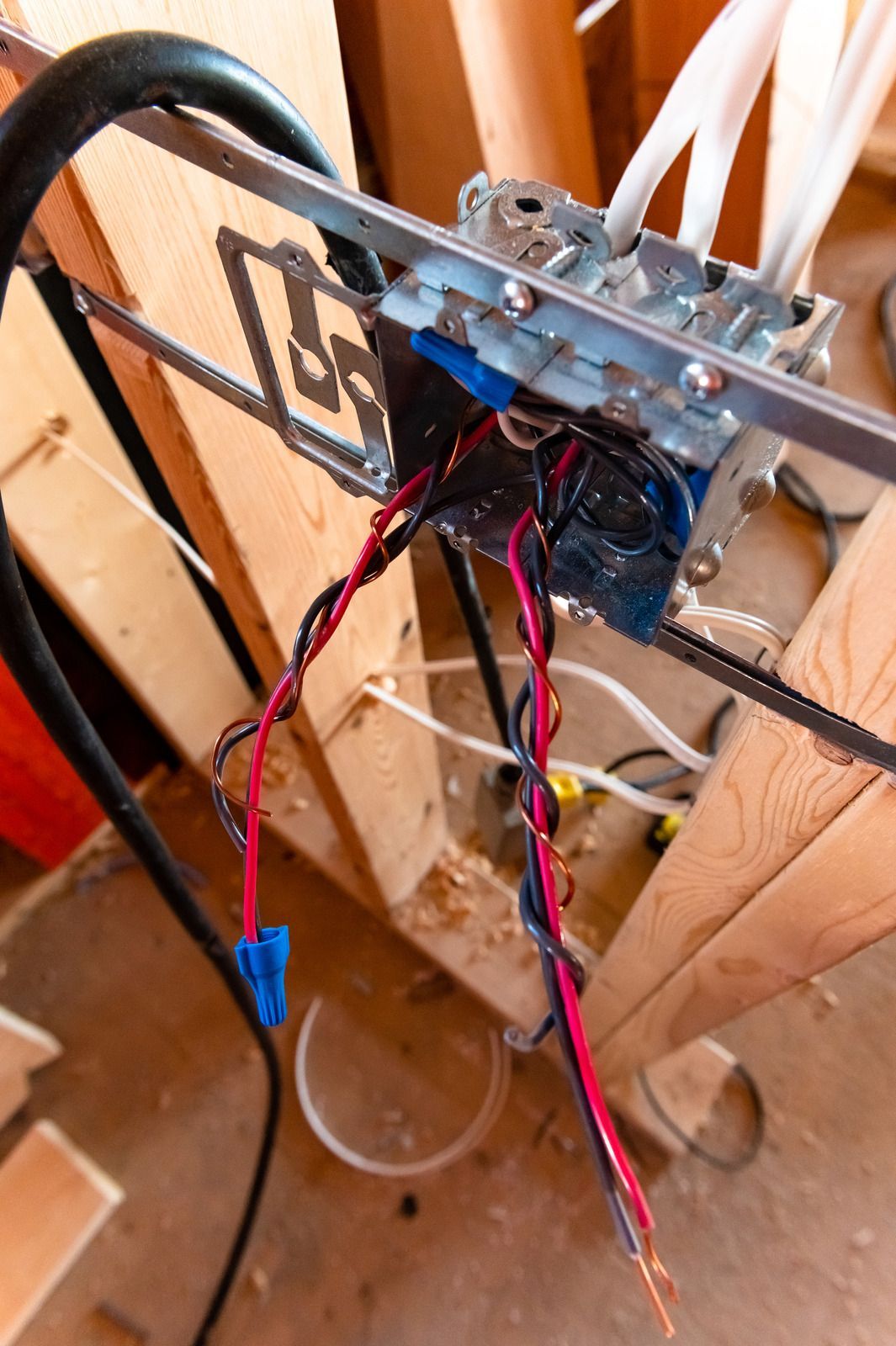 A man is working on a kitchen in a house under construction