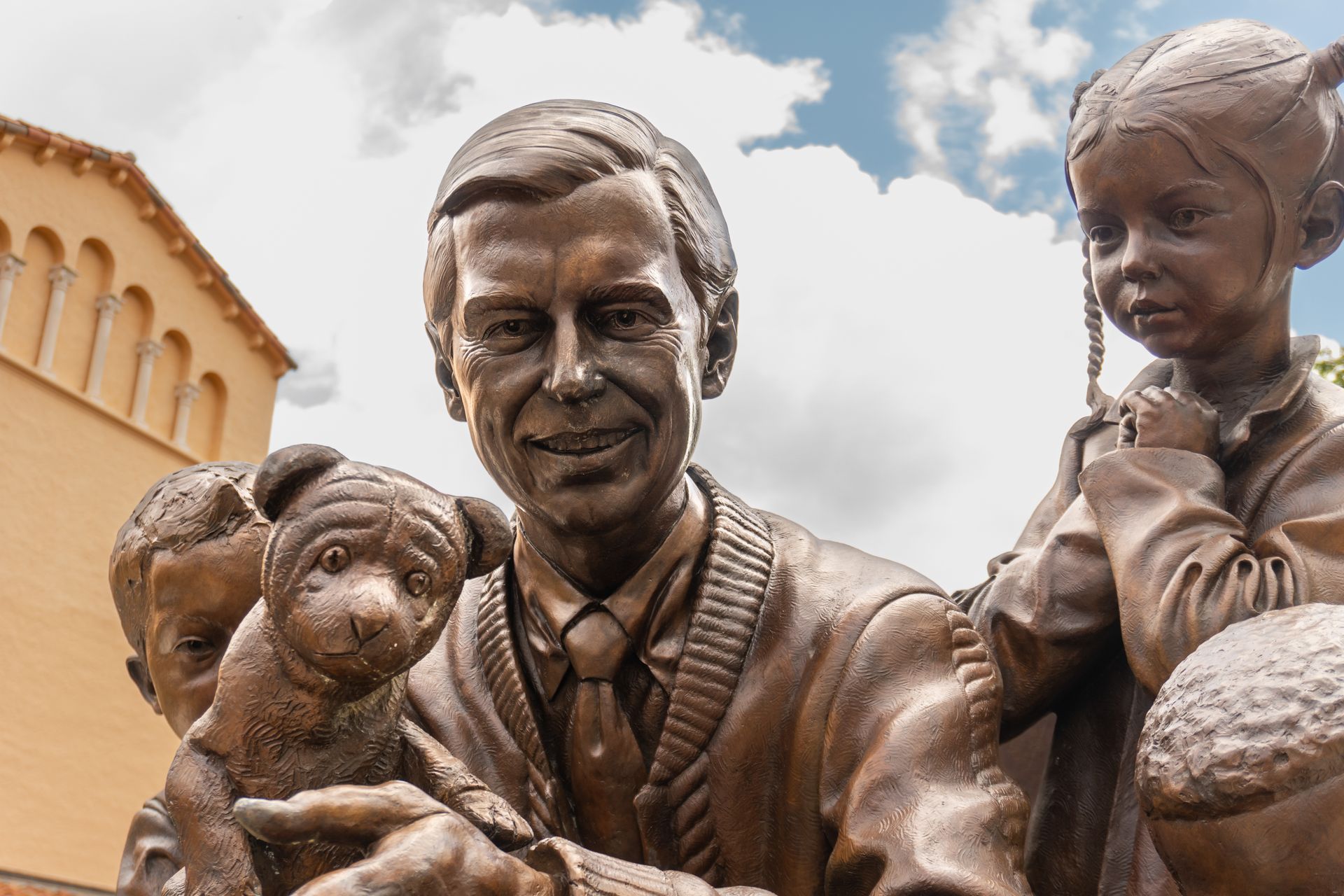 Statue of Fred Rogers with children and Daniel Tiger puppet in Winter Park, FL