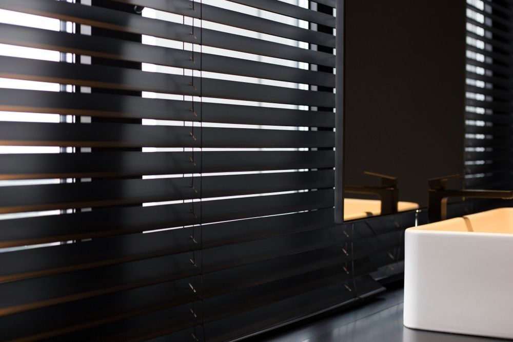 A Bathroom With Black Blinds and a White Sink — Curtain Haven & Blinds in Lake Cathie, NSW
