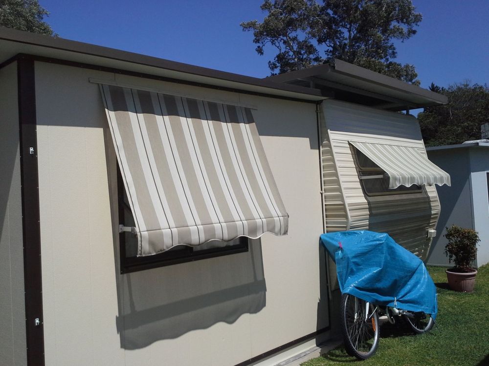 A House With a Striped Awning on the Window — Curtain Haven & Blinds in Laurieton, NSW