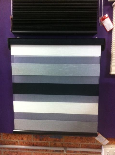 A Striped Blind is Hanging on a Purple Wall — Curtain Haven & Blinds in Laurieton, NSW