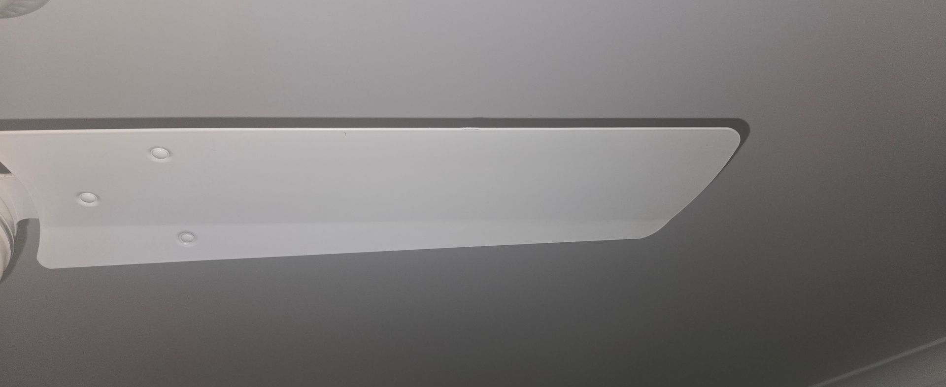 Stainless steel kitchen sink with faucet and drain in a clean countertop nook