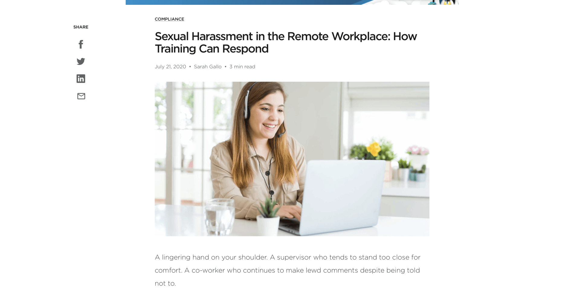 A woman is sitting at a table using a laptop computer.
