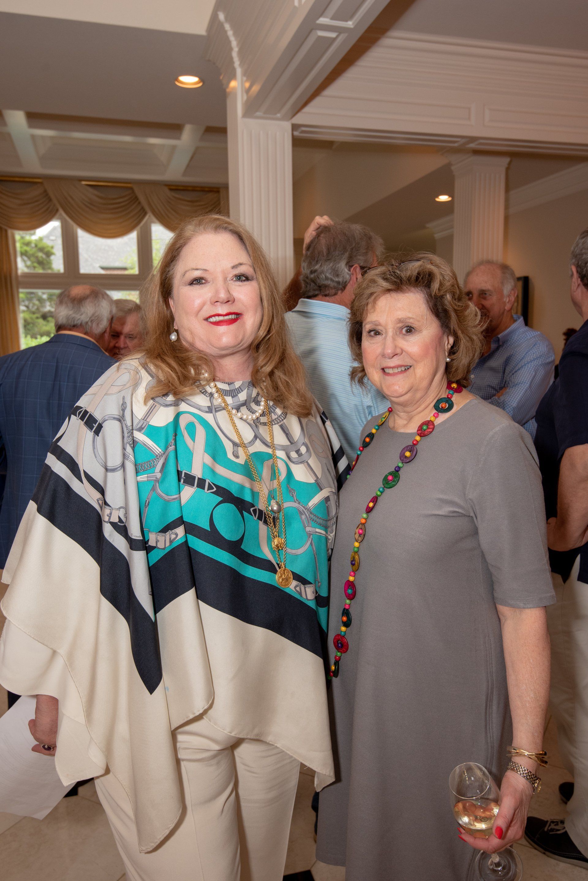 Two women are standing next to each other in a room.
