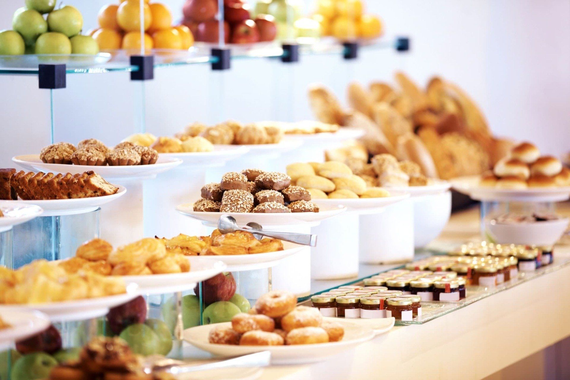 Buffet table with assorted baked goods and fruit.