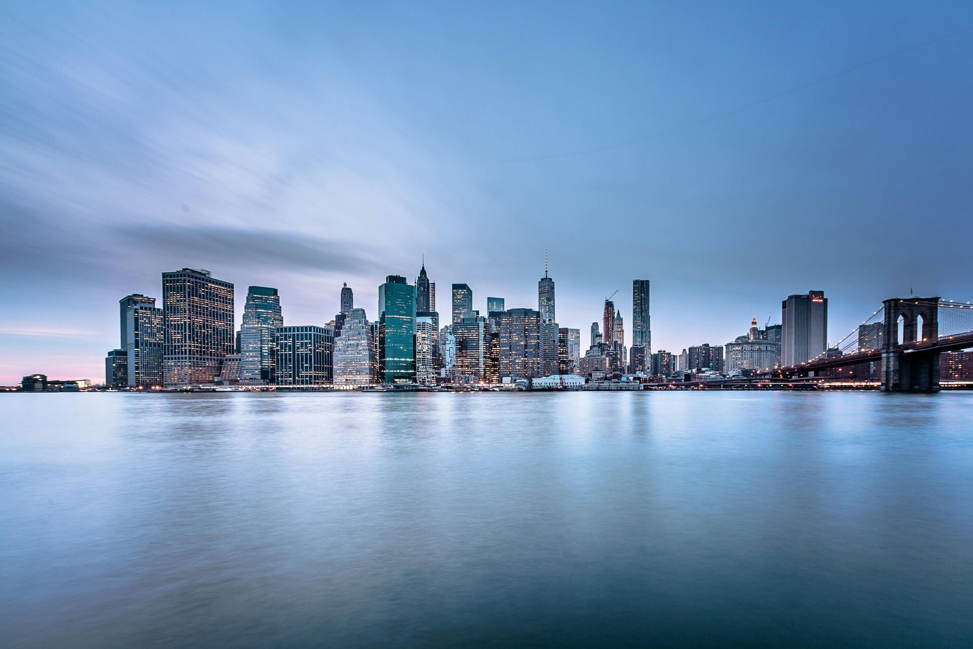 A long exposure of a city skyline over a body of water.