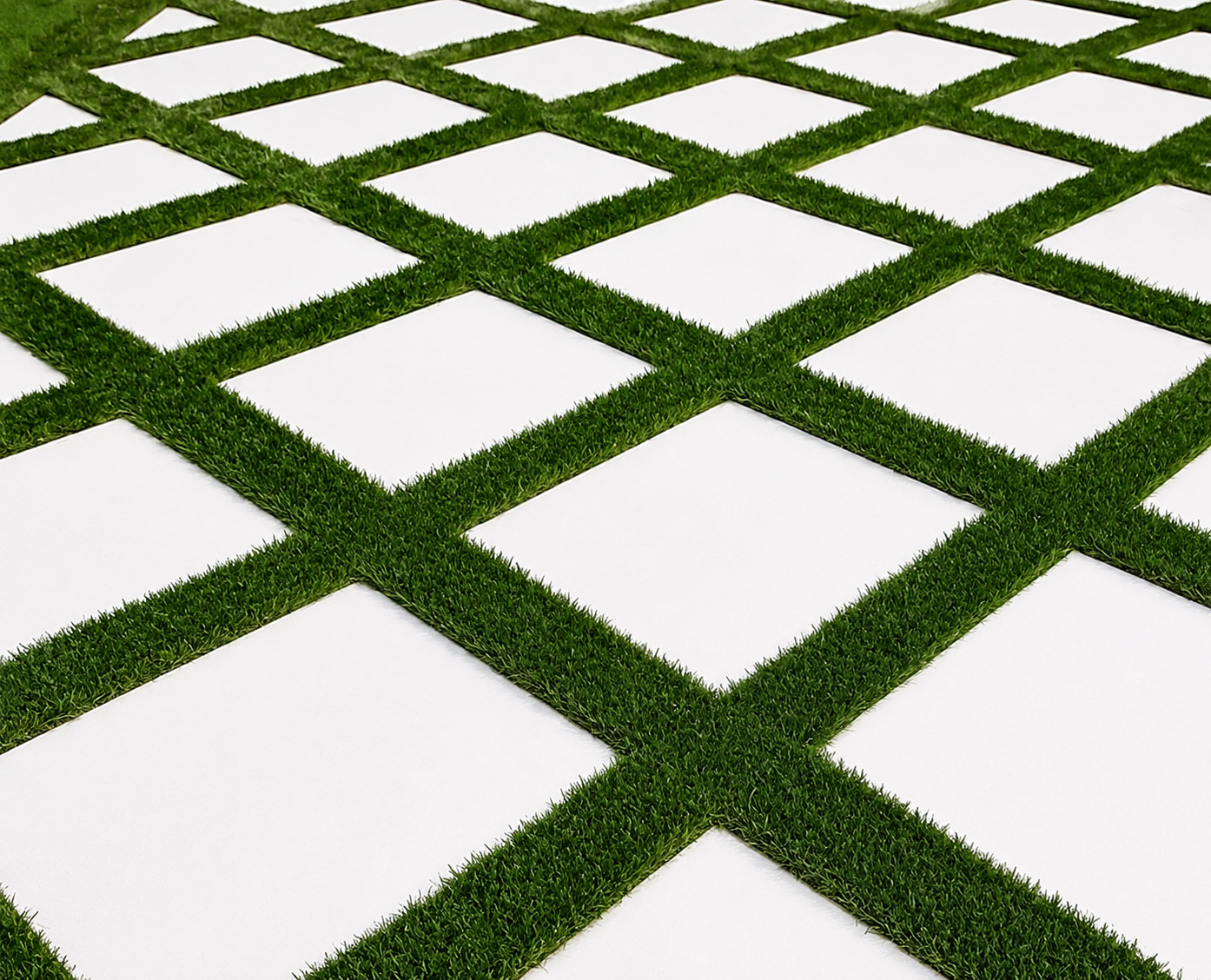 White square tiles separated by green grass in a geometric grid pattern
