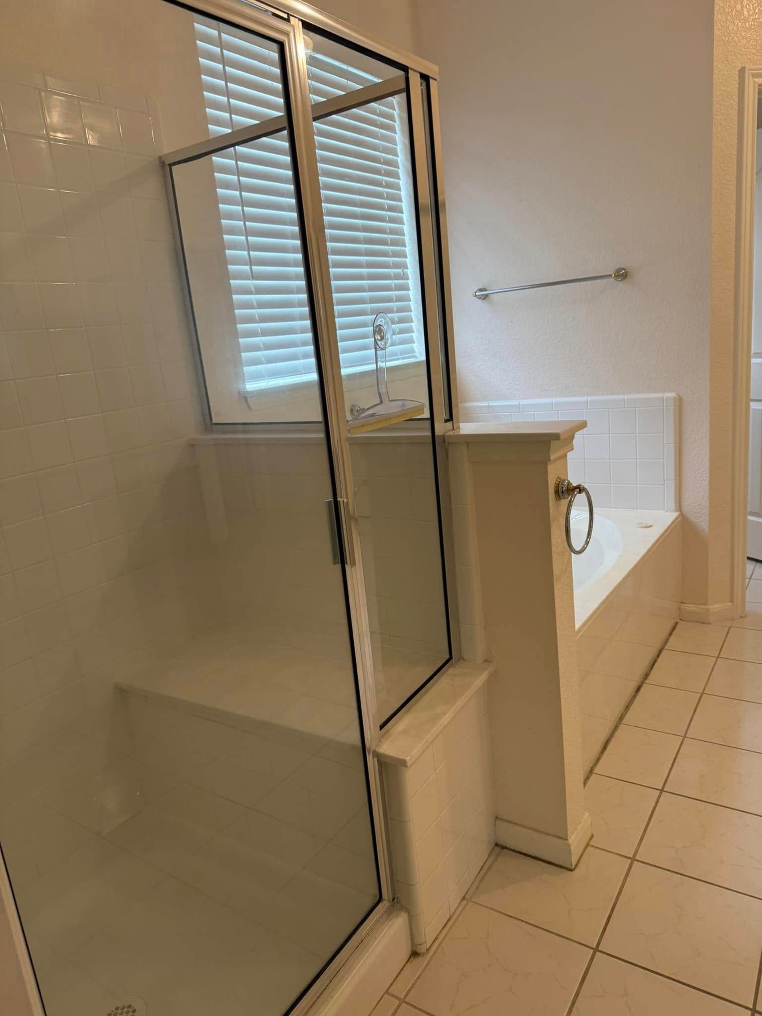 A bathroom with a bathtub and a walk in shower.