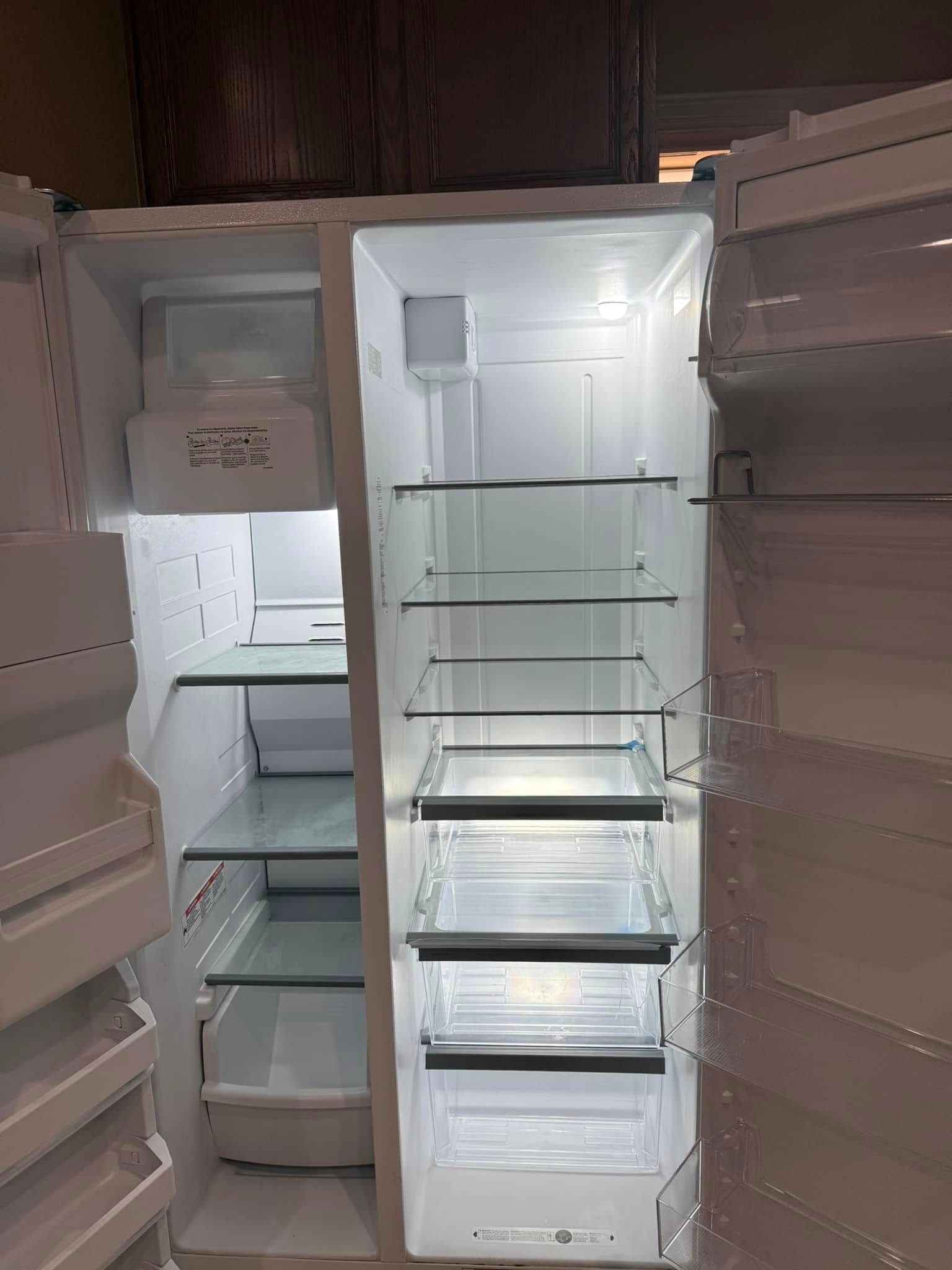 The inside of an empty refrigerator with the door open.