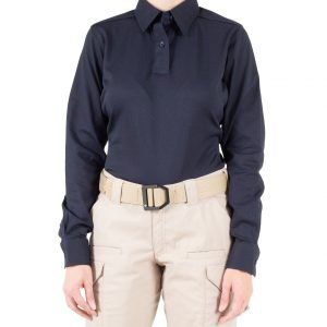 A woman is wearing a black polo shirt and khaki pants.