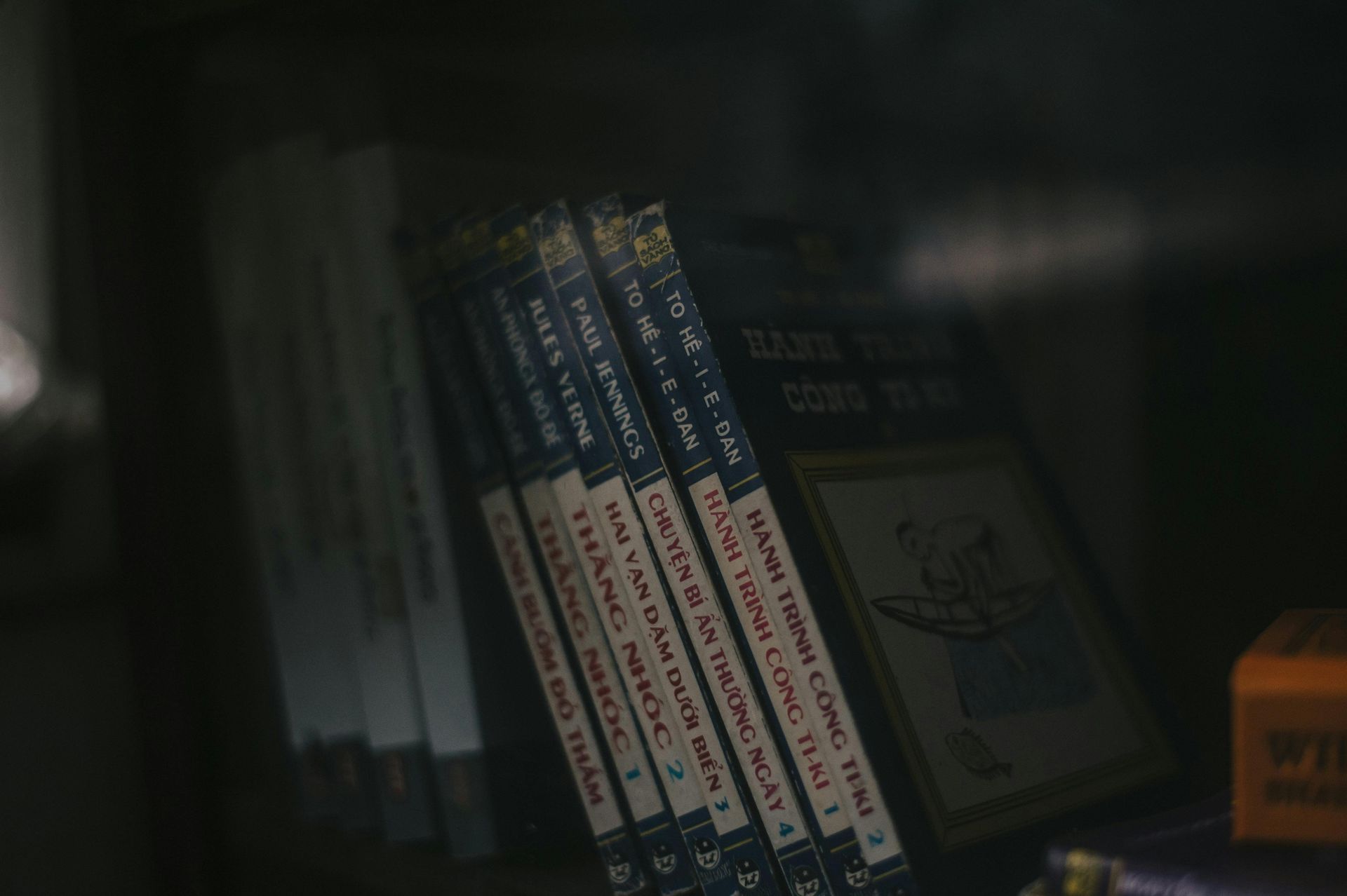A row of books sitting on top of each other on a shelf