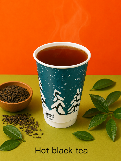 Hot black tea in a blue cup with tea leaves and green herbs on an orange background