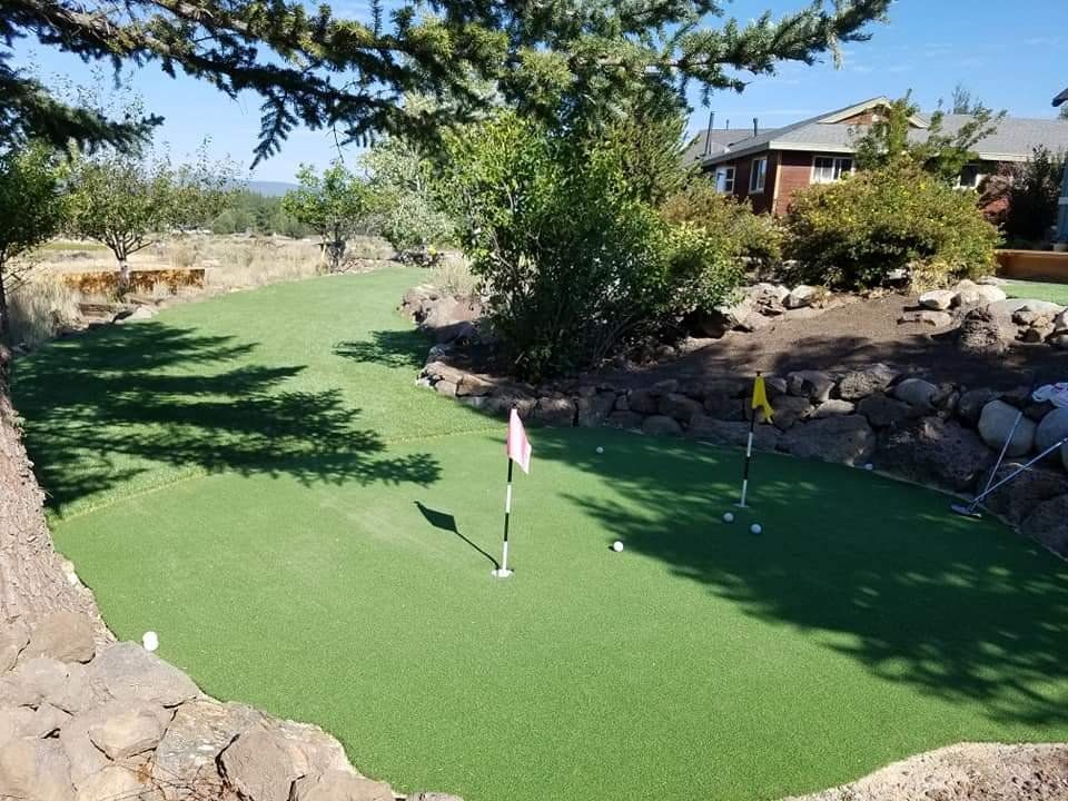 A putting green with a flag in the middle of it