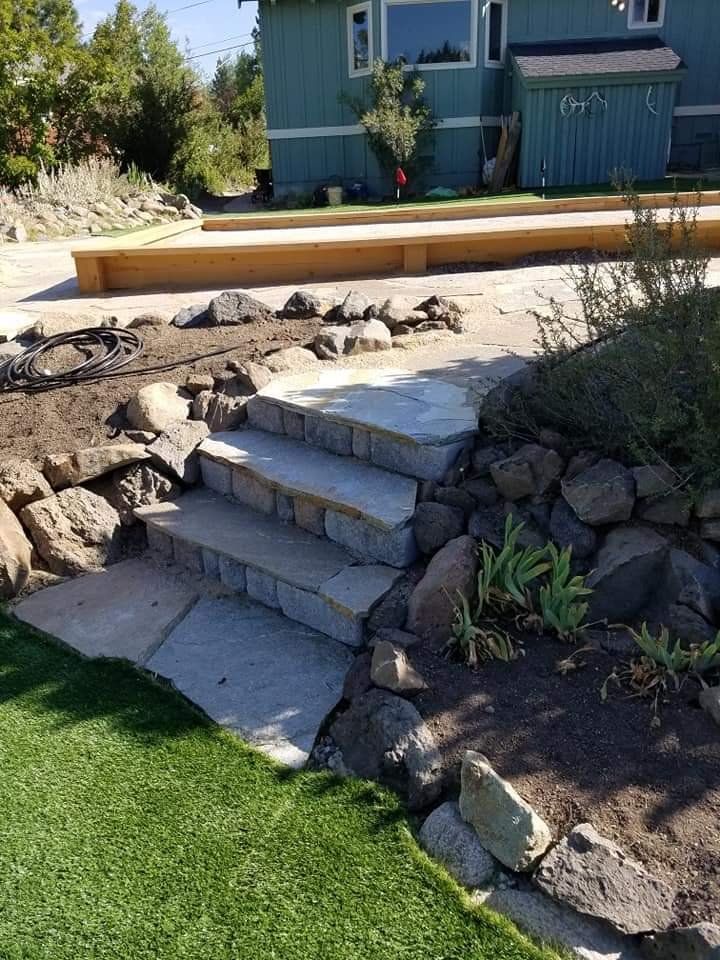 There are stairs leading up to a house in the background.