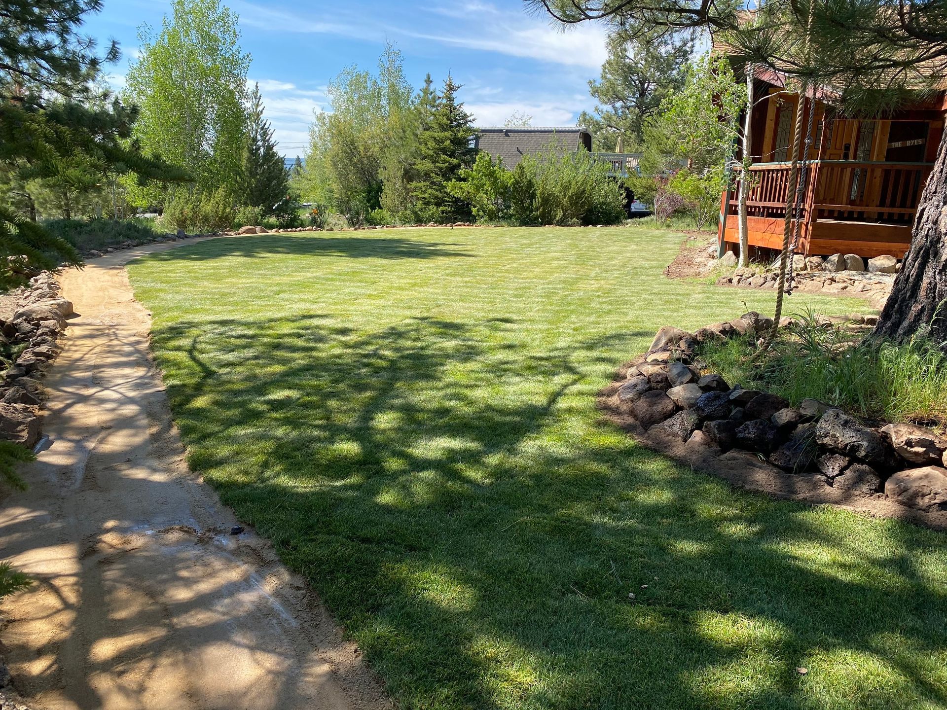 There is a path leading to a house in the background.